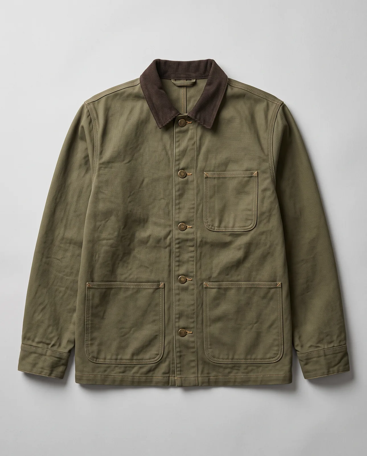 Nano Banana 2 output: olive canvas chore jacket with a brown corduroy collar, brass buttons and three patch pockets laid flat on grey paper