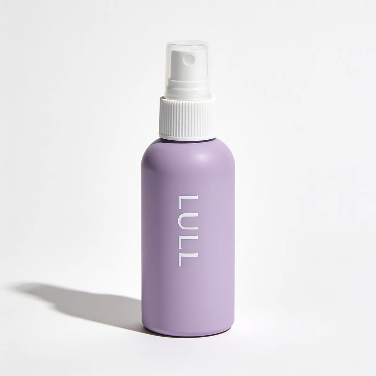 Reference image: lavender spray bottle of leave-in hair mist with a white sprayer and the word LULL, on white